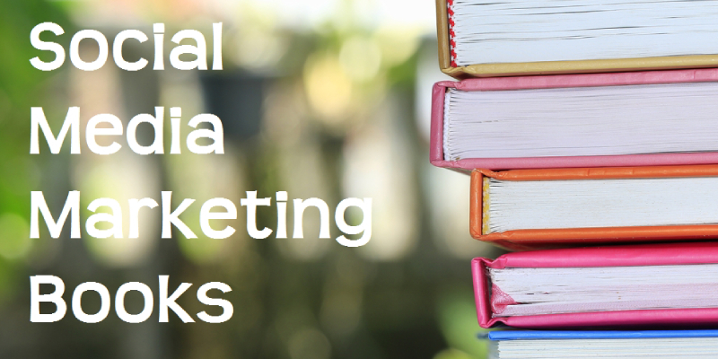 A Pile Of Books About Social Media Marketing In A Blurred Library Background.