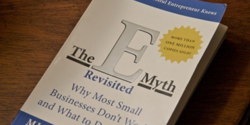 The EMyth Revisited - A Book About Online Marketing Placed On The Wooden Table.