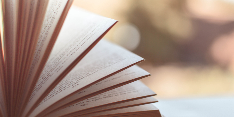 A Closeup Look Of An Opened Book Was Placed On The Table.