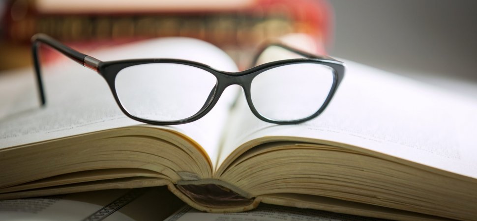 A Book About Entrepreneur Placed Opened On The Table And A Spectagles Over It.