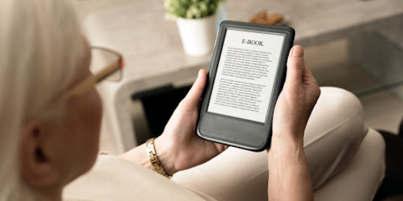 A Woman Reading An E-Book About Marketing.